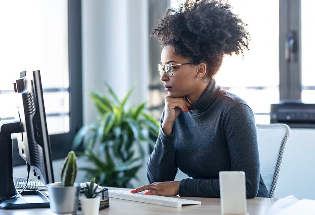About Section - business woman working while making video call with computer sitting in the office